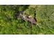 Aerial view of a secluded home surrounded by dense, vibrant green forest, offering privacy and a connection with nature at 111 Standing Rock Rd, Chapel Hill, NC 27516