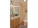 Cozy bathroom featuring natural wood cabinetry, warm lighting, and elegant fixtures at 111 Standing Rock Rd, Chapel Hill, NC 27516