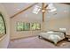 Spacious bedroom with vaulted ceiling, fan, skylights and large windows, offering serene views at 111 Standing Rock Rd, Chapel Hill, NC 27516