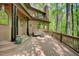 Inviting deck with outdoor seating, complemented by the natural beauty of the surrounding forest and tranquil setting at 111 Standing Rock Rd, Chapel Hill, NC 27516