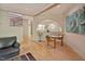 Open floor plan with a dining room featuring a round table, unique artwork, and views into the adjacent kitchen and living area at 111 Standing Rock Rd, Chapel Hill, NC 27516
