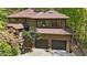 Stunning two-story house with a two-car garage and beautiful wood exterior nestled in a lush forest setting at 111 Standing Rock Rd, Chapel Hill, NC 27516