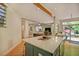 Open concept kitchen with a large island with a quartz countertop extending into a living room with a wooden ceiling at 111 Standing Rock Rd, Chapel Hill, NC 27516
