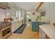 Bright kitchen with white cabinets, stainless steel appliances, a Wolf oven and an island with a contrasting cabinet color at 111 Standing Rock Rd, Chapel Hill, NC 27516