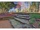 Tranquil outdoor space featuring stone steps surrounded by blooming trees, creating a serene and natural landscape at 111 Standing Rock Rd, Chapel Hill, NC 27516
