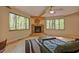 Living room showcasing a stone fireplace, large windows, and hardwood floors creating a cozy and inviting atmosphere at 111 Standing Rock Rd, Chapel Hill, NC 27516