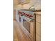 Close-up of a Wolf oven with red knobs and stainless-steel finish adding a premium touch to the kitchen at 111 Standing Rock Rd, Chapel Hill, NC 27516