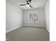 Empty bedroom with neutral carpet, ceiling fan, and a bright window view at 117 Pierce Rd, Garner, NC 27529