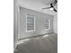 Bright bedroom with two windows and a ceiling fan offering both light and ventilation at 117 Pierce Rd, Garner, NC 27529