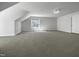 Spacious bonus room with neutral carpet, angled ceiling, and a window offering natural light at 117 Pierce Rd, Garner, NC 27529