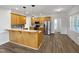 Eat-in kitchen boasts wooden cabinetry, stainless steel appliances, and bar seating at 117 Pierce Rd, Garner, NC 27529