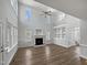 Bright living room with high ceilings, fireplace, built-in shelves, with wood flooring at 117 Pierce Rd, Garner, NC 27529