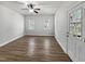 Spacious living room features hardwood floors, bright windows, and a ceiling fan at 117 Pierce Rd, Garner, NC 27529