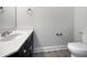 Stylish powder room with decorative tile floor, modern vanity and fixtures at 117 Pierce Rd, Garner, NC 27529
