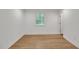 Bright bedroom features wood-look flooring, a window, and fresh, neutral paint at 1204 Pecan Pl, Durham, NC 27704