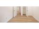 Spacious bedroom with wood-look flooring and multiple doorways at 1204 Pecan Pl, Durham, NC 27704