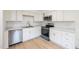 Corner view of the kitchen with stainless steel appliances at 1204 Pecan Pl, Durham, NC 27704