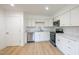 Bright kitchen featuring white cabinets and modern stainless steel appliances at 1204 Pecan Pl, Durham, NC 27704