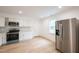 Kitchen featuring white cabinets, stainless steel appliances, and a stainless steel refrigerator at 1204 Pecan Pl, Durham, NC 27704