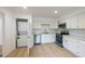 Bright kitchen featuring white cabinets and a washer/dryer at 1204 Pecan Pl, Durham, NC 27704