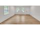 Living room with wood-look flooring, natural light, and neutral paint at 1204 Pecan Pl, Durham, NC 27704