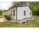 Side view of a home featuring white siding, manicured rock bed with young plants and flowers at 1204 Pecan Pl, Durham, NC 27704