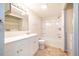 Bright bathroom with tub and shower combo plus vanity and washing machine and dryer at 121 Westview Dr # 43, Carrboro, NC 27510