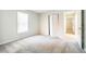 Bright bedroom with a window, closet with bi-fold doors, neutral carpeting, and entrance to another room at 121 Westview Dr # 43, Carrboro, NC 27510