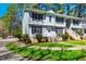Inviting townhome with manicured lawn, mature trees, and a classic light blue color scheme at 121 Westview Dr # 43, Carrboro, NC 27510