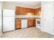 Functional kitchen space with tile floor, wood cabinets, and essential appliances at 121 Westview Dr # 43, Carrboro, NC 27510