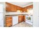 Well-maintained kitchen showcasing white appliances and wood cabinets at 121 Westview Dr # 43, Carrboro, NC 27510