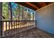 View from porch with wood ceiling, wooden railing, and view of tall trees in the distance at 121 Westview Dr # 43, Carrboro, NC 27510