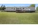 Exterior view of the home's back, showcasing the deck and spacious yard at 122 Blueberry Dr, Selma, NC 27576