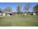Expansive backyard featuring multiple storage sheds, trees, and open green space at 122 Blueberry Dr, Selma, NC 27576