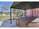 Relaxing deck area featuring a hot tub, hanging chair, and overhead shelter at 122 Blueberry Dr, Selma, NC 27576