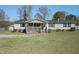 Charming single-story home featuring a cozy porch and well-maintained front yard and a detached shed at 122 Blueberry Dr, Selma, NC 27576