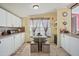 Bright kitchen area with an eat-in kitchen, great natural light and white cabinets at 122 Blueberry Dr, Selma, NC 27576