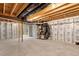 Unfinished basement with styrofoam insulation, exposed pipes, and concrete floor ready to be finished to your liking at 1423 Bridgewater Dr, Durham, NC 27704