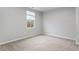 Bright bedroom features a window and neutral carpet creating a serene and comfortable atmosphere at 1423 Bridgewater Dr, Durham, NC 27704