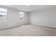 A bedroom with two windows that allow natural light to brighten the neutral carpet and walls at 1423 Bridgewater Dr, Durham, NC 27704