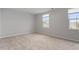 Bright, neutral bedroom with natural light streaming through two windows, perfect for relaxation at 1423 Bridgewater Dr, Durham, NC 27704