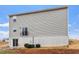 Exterior view of house with gray siding, with sliding door and walk-out basement at 1423 Bridgewater Dr, Durham, NC 27704