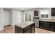 This kitchen boasts modern appliances, dark cabinets and a central island with countertop at 1423 Bridgewater Dr, Durham, NC 27704