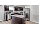 Modern kitchen features stainless steel appliances, dark cabinets, and granite countertops at 1423 Bridgewater Dr, Durham, NC 27704