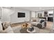 Bright living room featuring hardwood floors, white sofas, a TV, stairs and dark kitchen cabinets at 1423 Bridgewater Dr, Durham, NC 27704