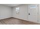 Living room with hardwood floors, white walls, front door and a window with blinds at 1423 Bridgewater Dr, Durham, NC 27704