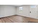 Living room with hardwood floors, white walls, front door and a window with blinds at 1423 Bridgewater Dr, Durham, NC 27704