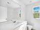 Clean bathroom with a white sink, toilet, and shower over bathtub, lit by bright natural light at 1546 Crescent Townes Way, Raleigh, NC 27604