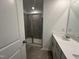 Clean bathroom featuring a tiled shower with glass doors and a modern vanity at 1546 Crescent Townes Way, Raleigh, NC 27604