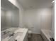 Bright bathroom featuring a vanity with a white countertop and a shower-tub combo at 1546 Crescent Townes Way, Raleigh, NC 27604
